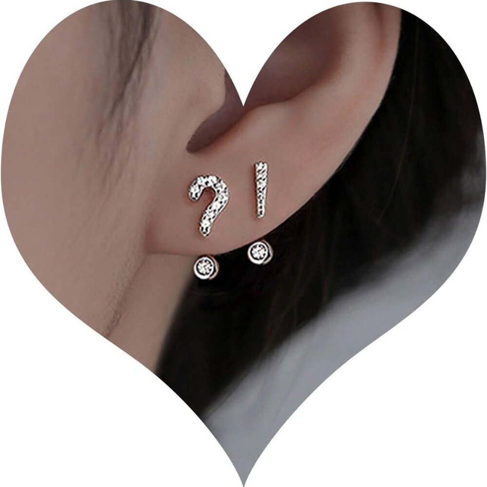 Tiny mismatched asymmetrical stud earrings with cubic zirconia and symbol design